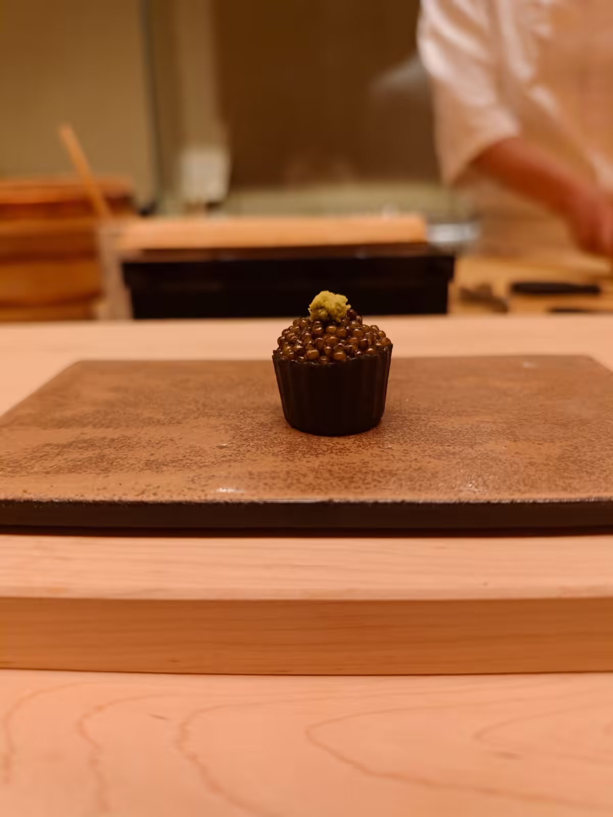 Black tartlet with caviar and fresh wasabi
